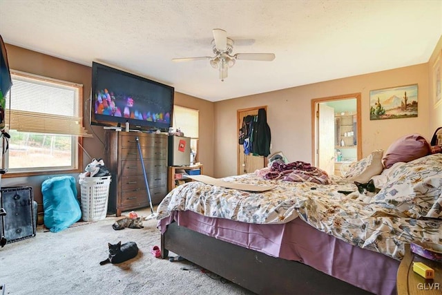 bedroom featuring carpet flooring, ceiling fan, a textured ceiling, and a closet