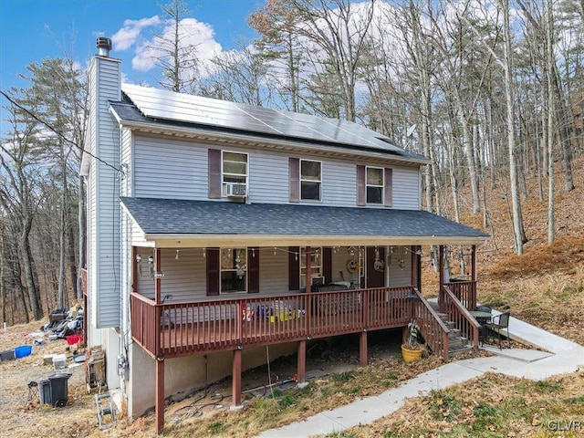 view of front facade featuring covered porch and solar panels