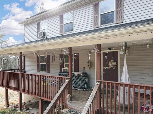 view of exterior entry with a porch and cooling unit