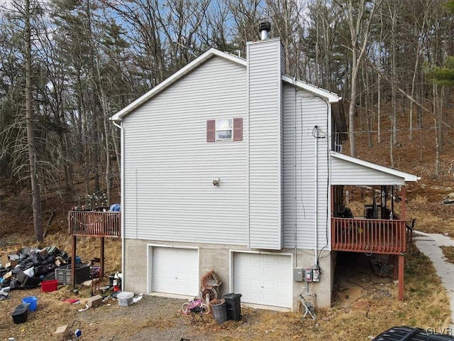 view of side of home with a garage and a deck