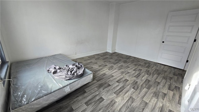 unfurnished bedroom with dark hardwood / wood-style floors