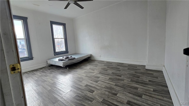 spare room with dark hardwood / wood-style floors and ceiling fan