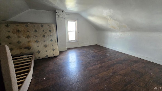 additional living space featuring lofted ceiling and dark wood-type flooring