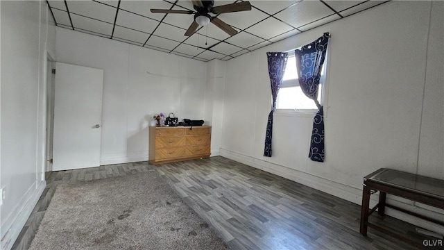 spare room with a paneled ceiling, hardwood / wood-style flooring, and ceiling fan