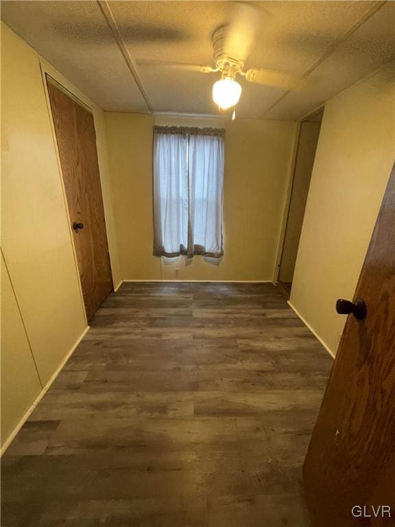 corridor with dark hardwood / wood-style floors