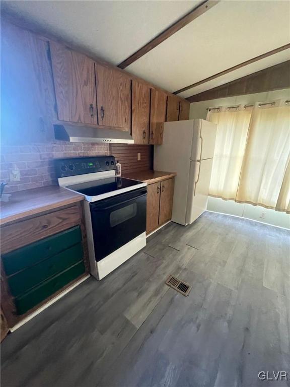 kitchen featuring vaulted ceiling with beams, light wood-type flooring, white appliances, and backsplash