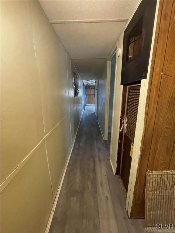 corridor with dark hardwood / wood-style flooring