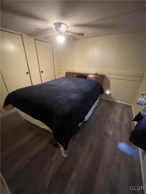 bedroom with ceiling fan and dark hardwood / wood-style floors