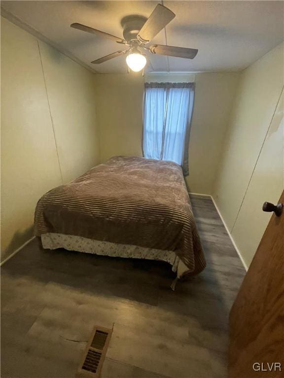 bedroom featuring dark hardwood / wood-style floors and ceiling fan