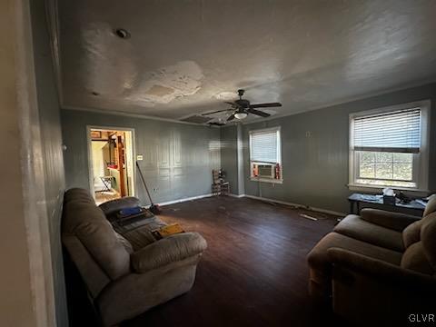 living room with ornamental molding, cooling unit, ceiling fan, and dark wood-type flooring