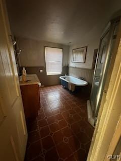 bathroom featuring vanity and independent shower and bath