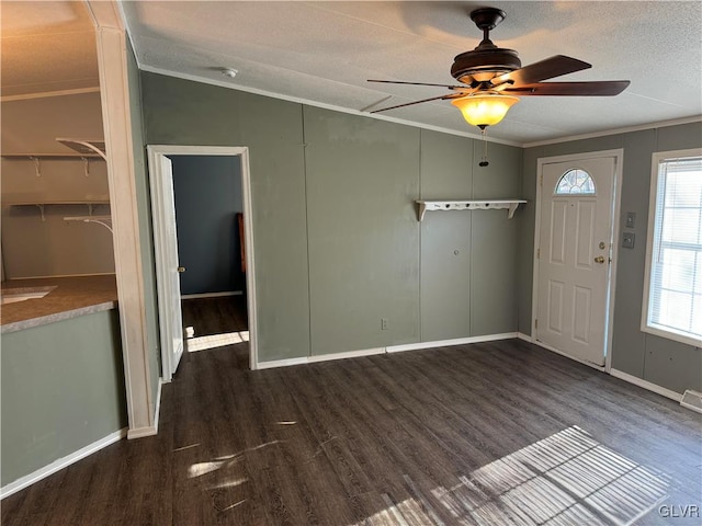 foyer with a textured ceiling, ceiling fan, crown molding, and dark hardwood / wood-style floors