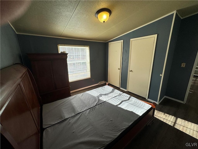 unfurnished bedroom featuring hardwood / wood-style floors, a textured ceiling, crown molding, and lofted ceiling