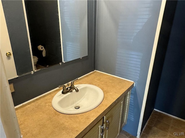 bathroom with vanity and toilet