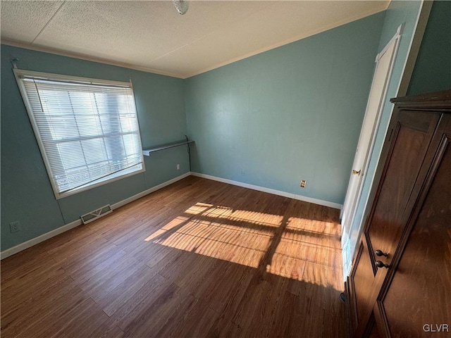 unfurnished room with wood-type flooring