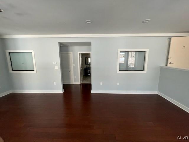 spare room featuring dark hardwood / wood-style flooring