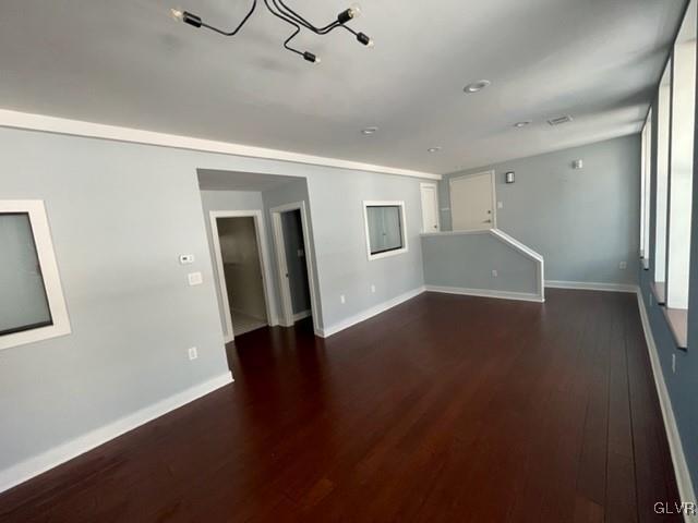 unfurnished living room featuring dark hardwood / wood-style floors