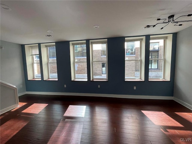 empty room with dark hardwood / wood-style floors