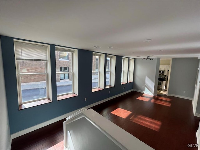 empty room featuring dark hardwood / wood-style flooring