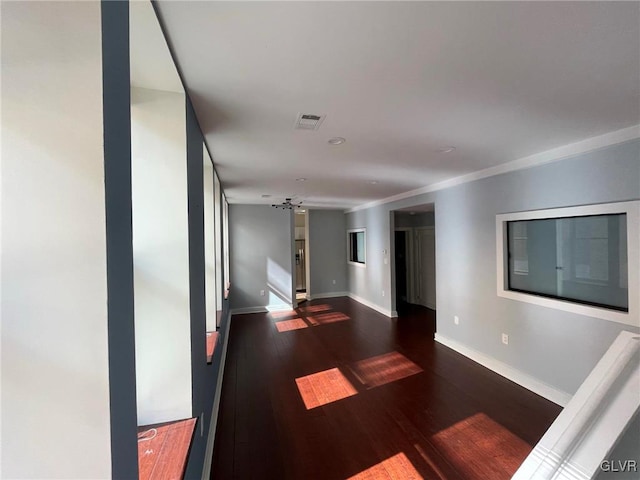 hallway featuring crown molding and dark wood-type flooring