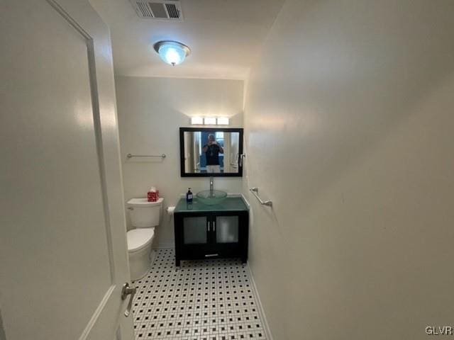 bathroom featuring vanity and toilet