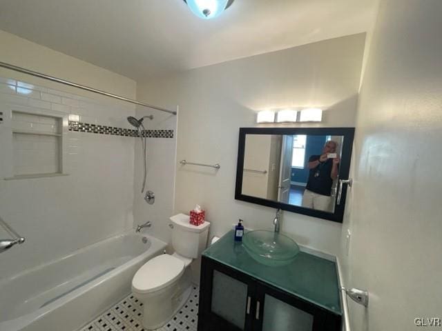 full bathroom featuring tile patterned floors, vanity, toilet, and tiled shower / bath