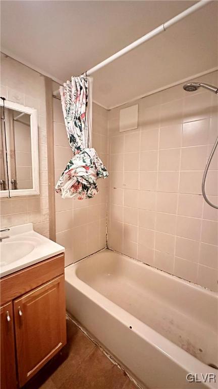 bathroom featuring tile patterned flooring, vanity, and shower / tub combo with curtain