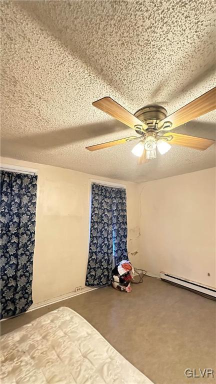 unfurnished bedroom with carpet, ceiling fan, a textured ceiling, and a baseboard radiator