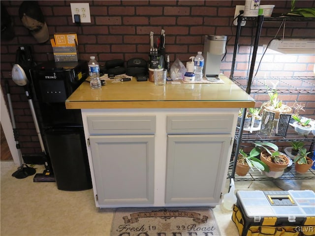 kitchen with white cabinets and light carpet