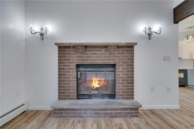 interior details with baseboard heating, a brick fireplace, decorative backsplash, and hardwood / wood-style flooring