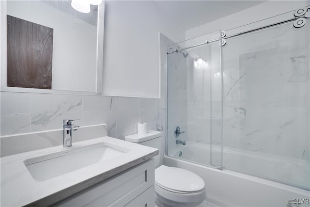 full bathroom featuring vanity, backsplash, combined bath / shower with glass door, toilet, and tile walls