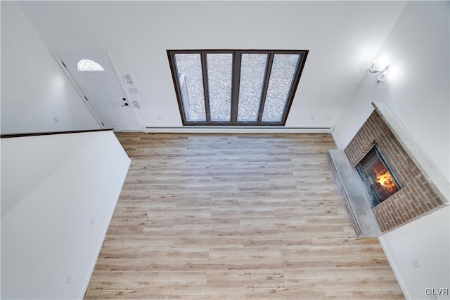 entryway with a fireplace and light hardwood / wood-style flooring