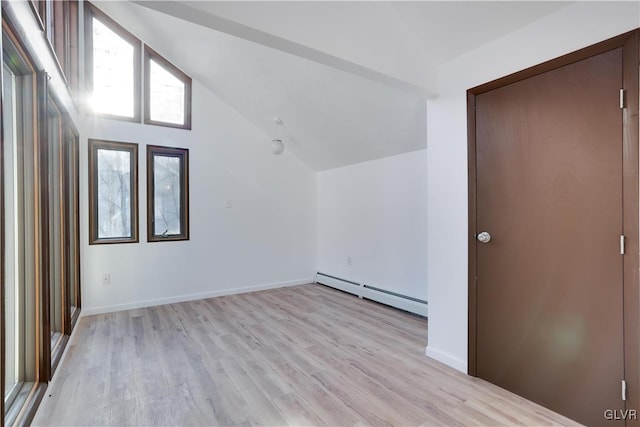 bonus room with a baseboard radiator, light hardwood / wood-style flooring, and lofted ceiling