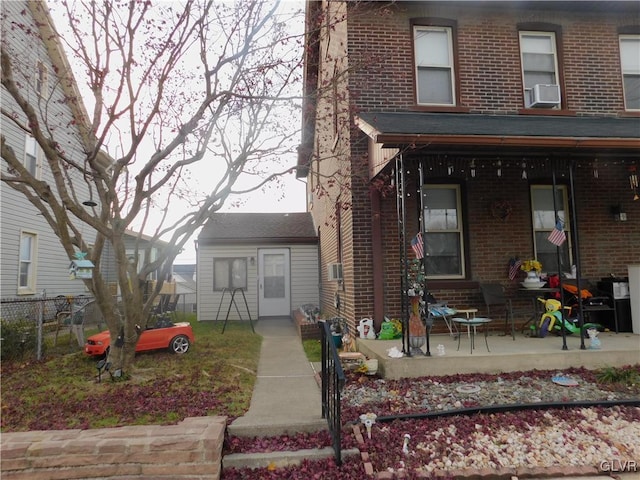 view of front of property featuring covered porch and cooling unit