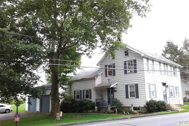 view of front of home featuring an outbuilding and a garage