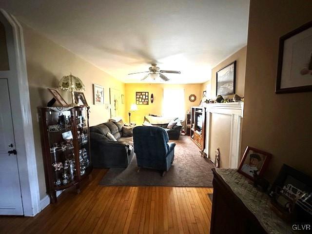 living room with hardwood / wood-style floors and ceiling fan