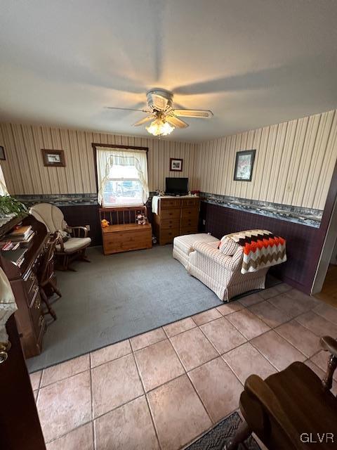 unfurnished living room with light tile patterned floors and ceiling fan