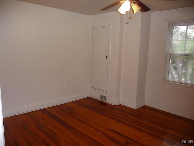 empty room featuring dark hardwood / wood-style floors and ceiling fan