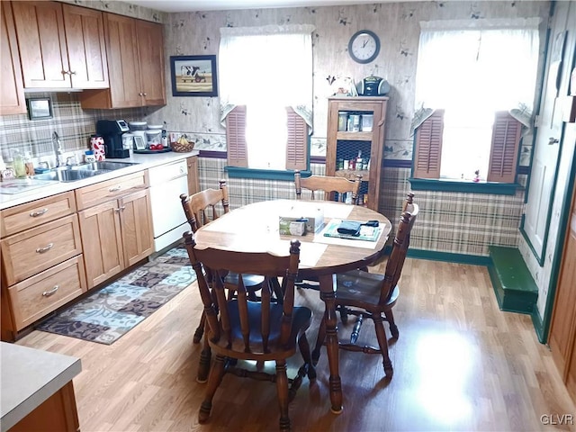 dining space featuring light hardwood / wood-style flooring, a healthy amount of sunlight, and sink