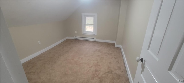 additional living space with light colored carpet, lofted ceiling, and a baseboard heating unit