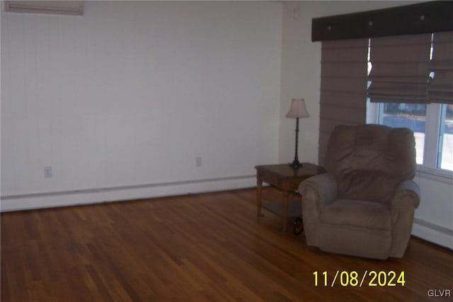 sitting room with dark hardwood / wood-style flooring and a baseboard heating unit