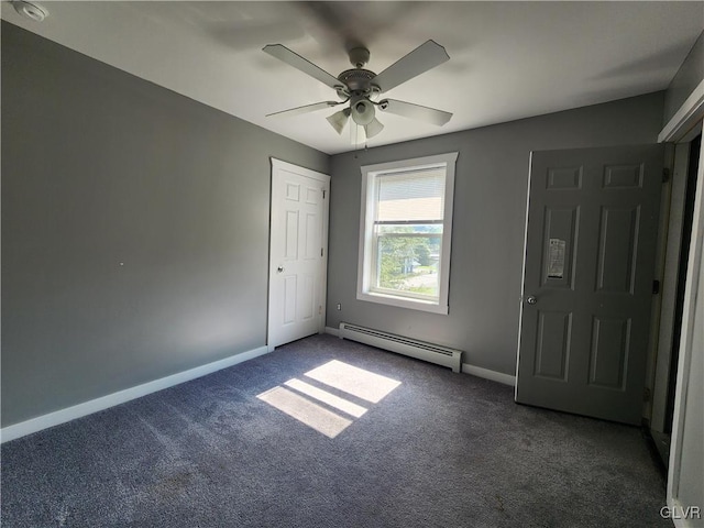 empty room featuring baseboard heating, ceiling fan, and carpet floors