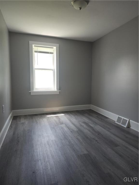 spare room with dark hardwood / wood-style flooring