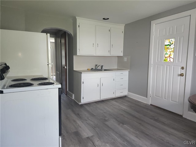 kitchen with white cabinets, dark hardwood / wood-style floors, white appliances, and sink