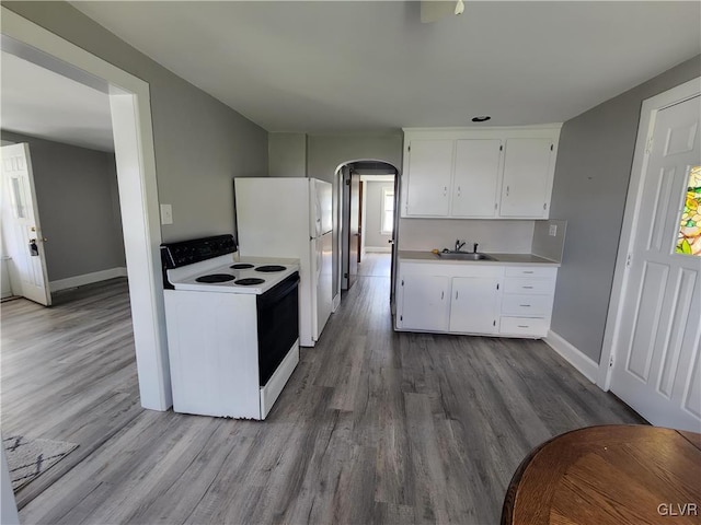 kitchen featuring white cabinetry, light hardwood / wood-style flooring, white appliances, and sink