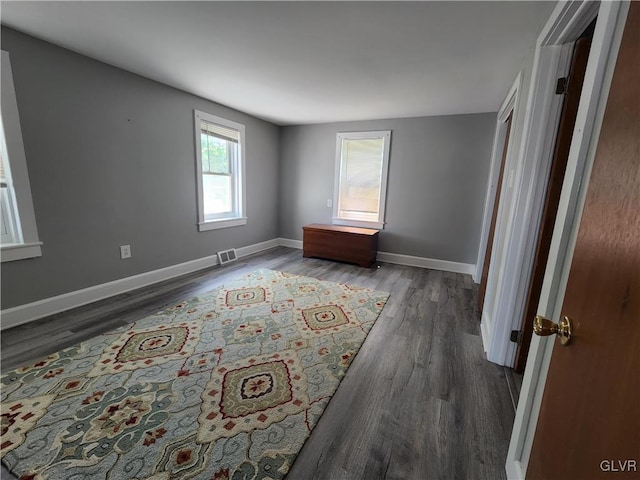 spare room with dark wood-type flooring