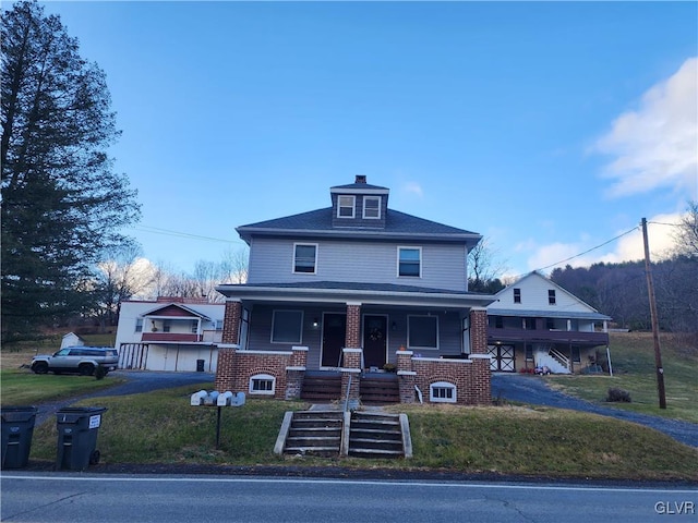 view of front facade with covered porch and a front yard