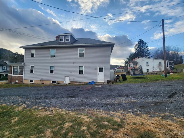 back of house featuring a trampoline