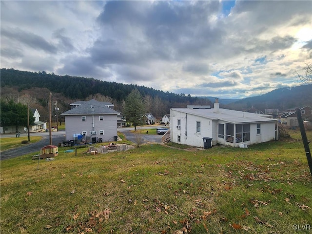 4400 Little Gap Rd, Lower Towamensing Tp, PA 18058 - back of house with a lawn, a chimney, a sunroom, and a view of trees