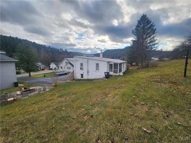 view of side of home featuring a lawn